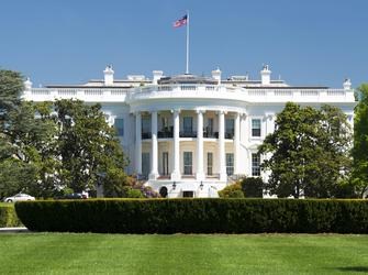 A large white building with a semi-circle of columns