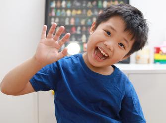boy waving his hand