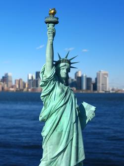 a large statue of a woman holding a book and a torch